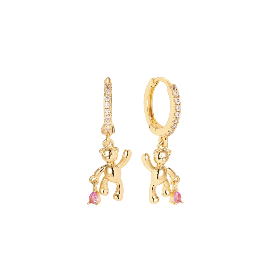 Gold pavé crystal huggie earrings with 3D sculptural gold teddy bear charms holding pink crystal teardrops, on a white background — Amie Teddy Bear Pavé Huggie Earrings by Ailani Jewels