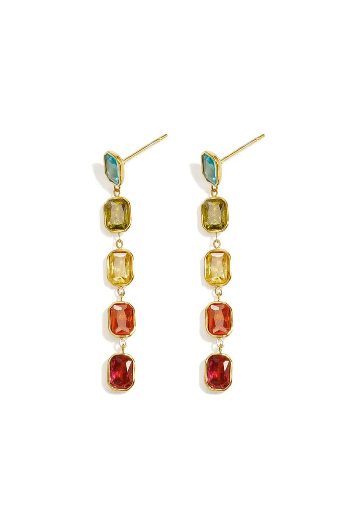 A pair of gold-plated stainless steel linear drop earrings featuring a vertical chain of five multi-coloured emerald-cut cubic zirconia crystals against a white background. camilla-multi-gemstone-linear-drop-earrings.webp