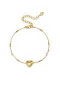 A gold-plated stainless steel chain station bracelet featuring a central beaded-border heart, cylindrical bar links, a small clear cubic zirconia stone, and a tiny pearl accent. adore-beaded-heart-station-bracelet.webp