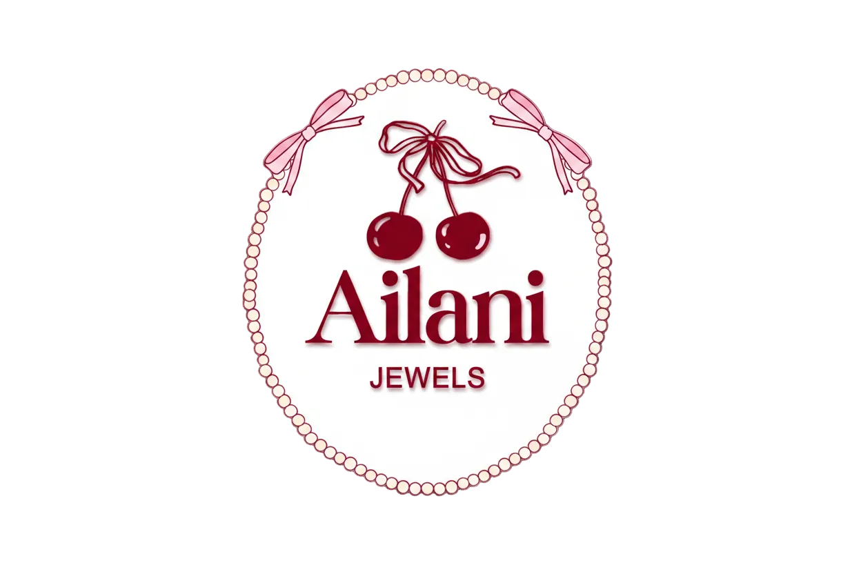 Ailani Jewels logo featuring a circular beaded border with pink bows, two cherries with a ribbon bow, and the brand name 'Ailani' with 'JEWELS' underneath, on a white background.
