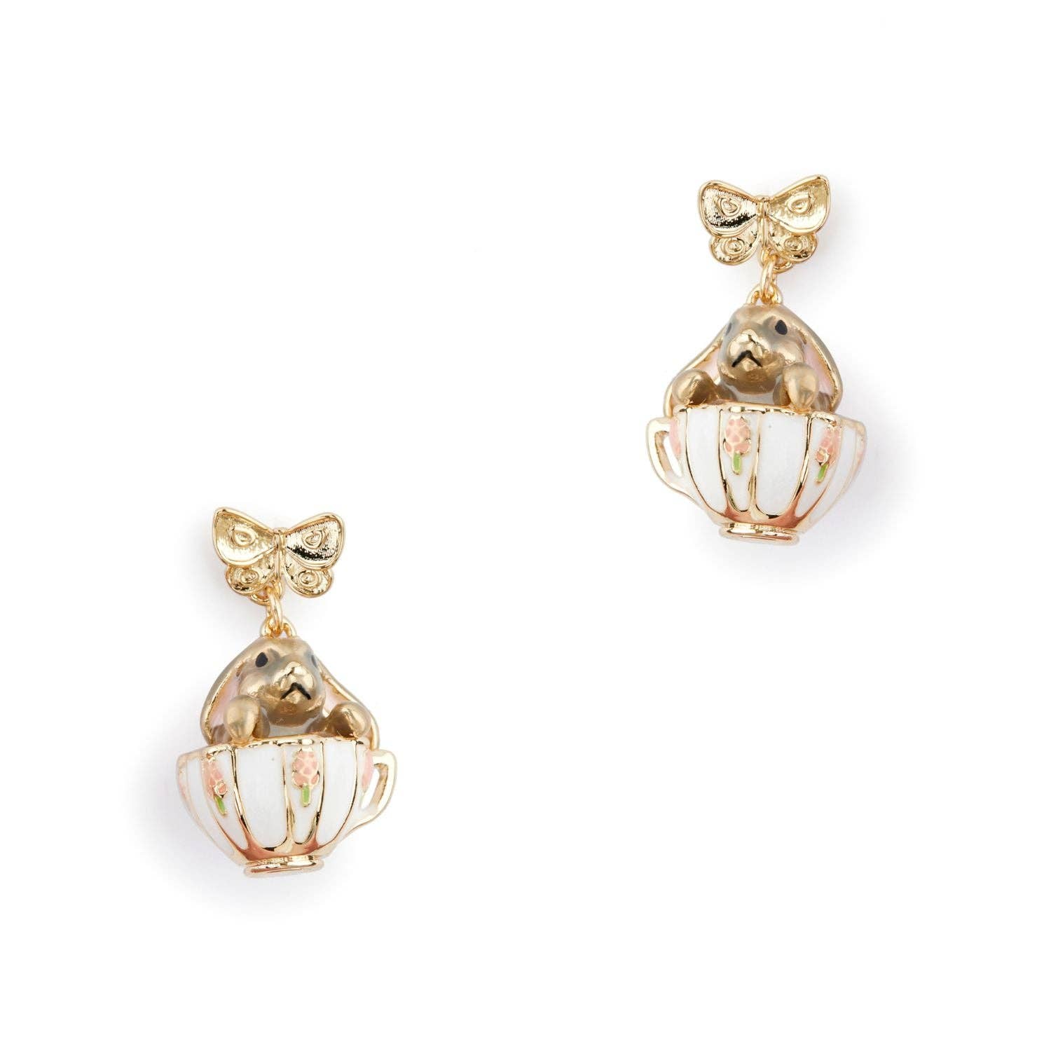 A pair of Bill Skinner gold drop earrings featuring a structured gold bow stud suspending a miniature white enamel teacup with a gold bunny inside.