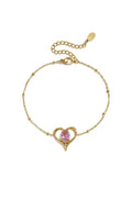 A gold-plated stainless steel chain station bracelet featuring a central open heart pendant with a prong-set oval pink cubic zirconia stone. amelie-pink-solitaire-heart-bracelet.webp