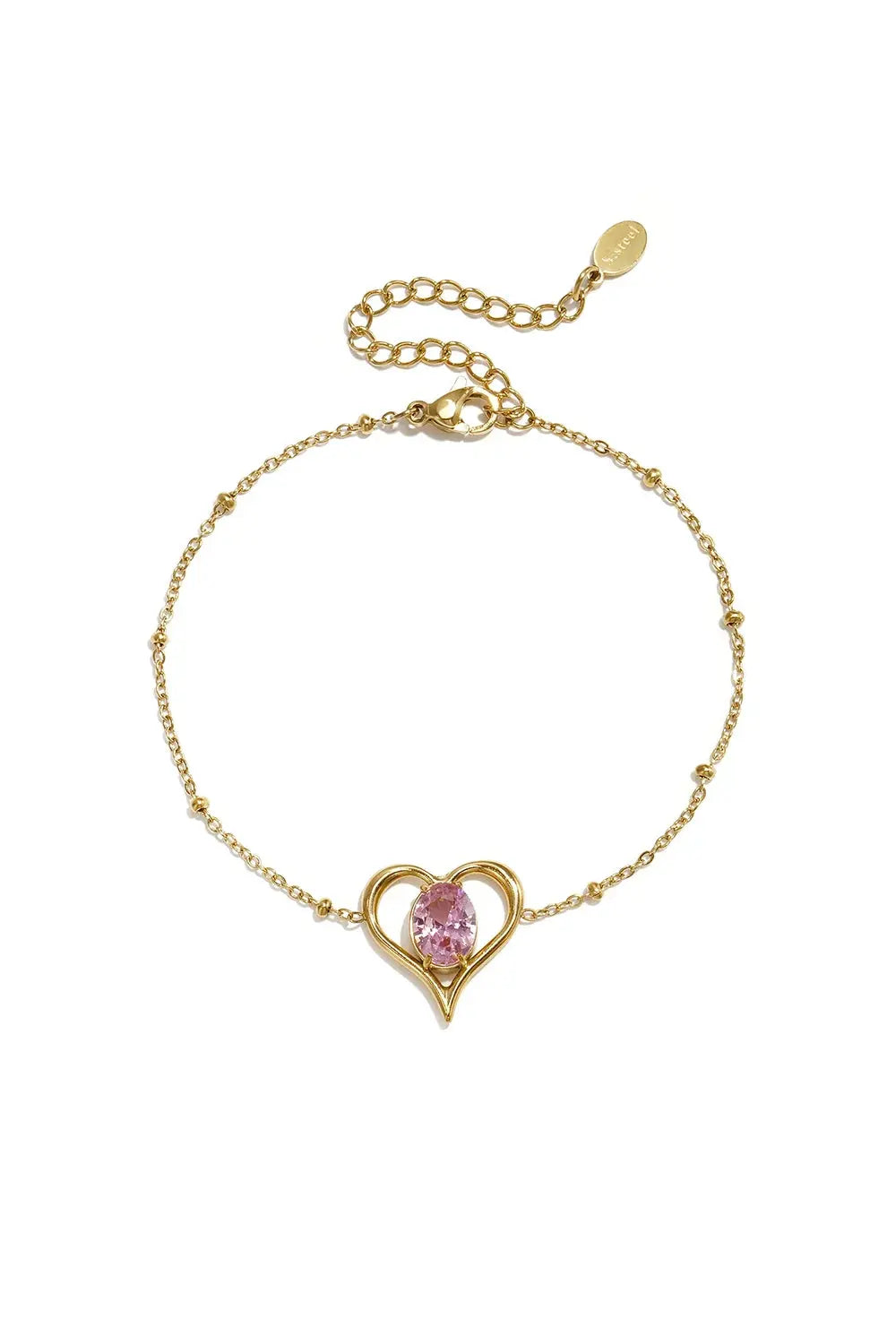 A gold-plated stainless steel chain station bracelet featuring a central open heart pendant with a prong-set oval pink cubic zirconia stone. amelie-pink-solitaire-heart-bracelet.webp