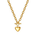 A chunky 18K gold link chain necklace featuring a front toggle clasp and a smooth, polished puffed heart pendant on a crisp white background.