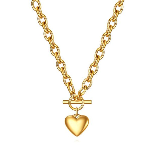 A chunky 18K gold link chain necklace featuring a front toggle clasp and a smooth, polished puffed heart pendant on a crisp white background.