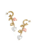 A pair of gold-plated half-hoop drop earrings featuring a cascading chain of charms including a flat gold heart, a 3D gold puffy heart, a marbled pink heart bead, and a large white pearl heart drop. amour-cascade-heart-earrings.webp
