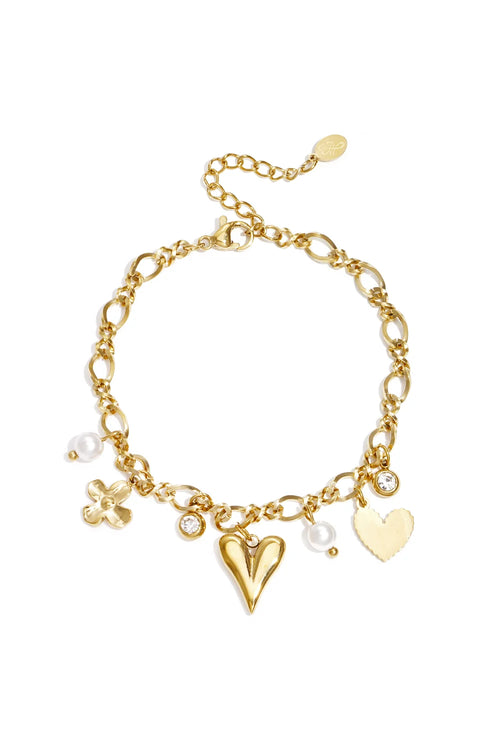 A gold-plated charm bracelet featuring a figure-eight link chain decorated with a central 3D puffy heart, a flat scalloped heart, a four-petal flower bloom, clear bezel crystals, and dangling white pearl beads. amour-cherie-charm-bracelet.webp