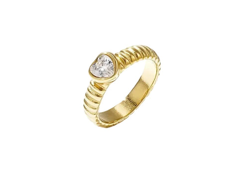 A gold-plated statement ring featuring a textured ribbed band set with a central brilliant-cut clear crystal heart solitaire inside a smooth bezel. amour-heart-ribbed-ring.webp