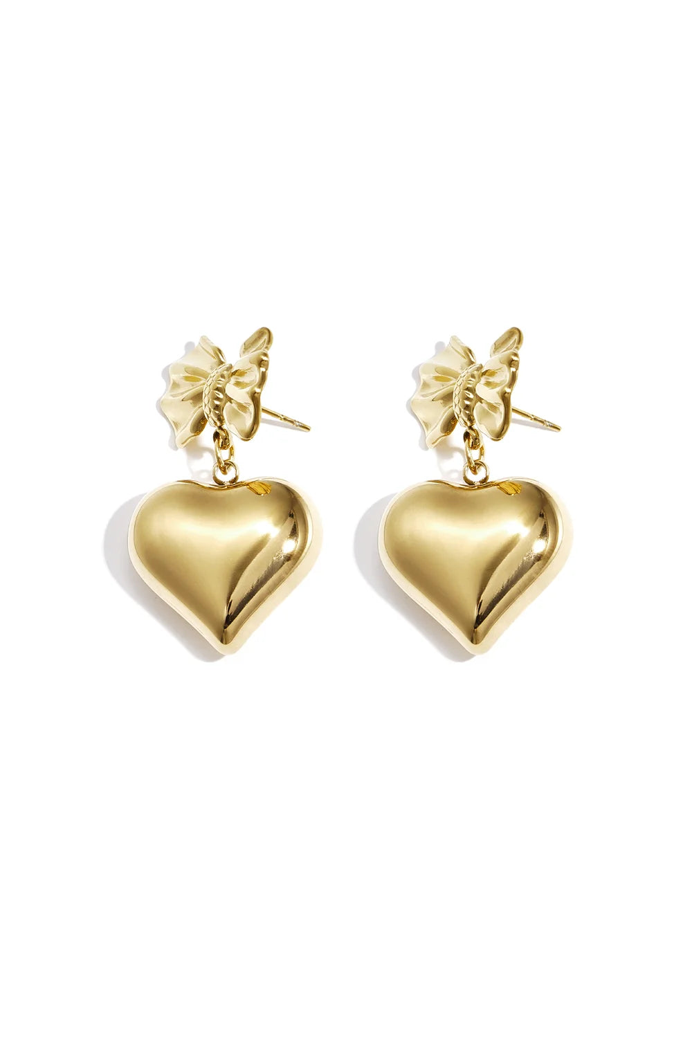 A pair of gold-plated drop earrings featuring a detailed 3D ribbon bow stud post suspending a large, high-polish three-dimensional puffy heart charm. amour-heart-bow-earrings.webp