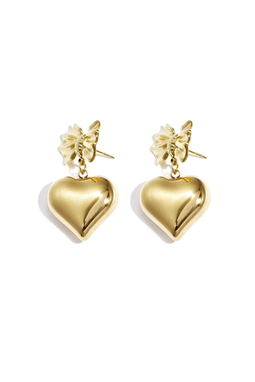 A pair of gold-plated drop earrings featuring a detailed 3D ribbon bow stud post suspending a large, high-polish three-dimensional puffy heart charm. amour-heart-bow-earrings.webp