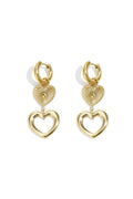 A pair of gold-plated stainless steel huggie hoop earrings featuring a cascading drop of a sunburst heart medallion and a larger open-heart charm against a white background. amour-tiered-sunburst-open-heart-drop-huggie-earrings.webp