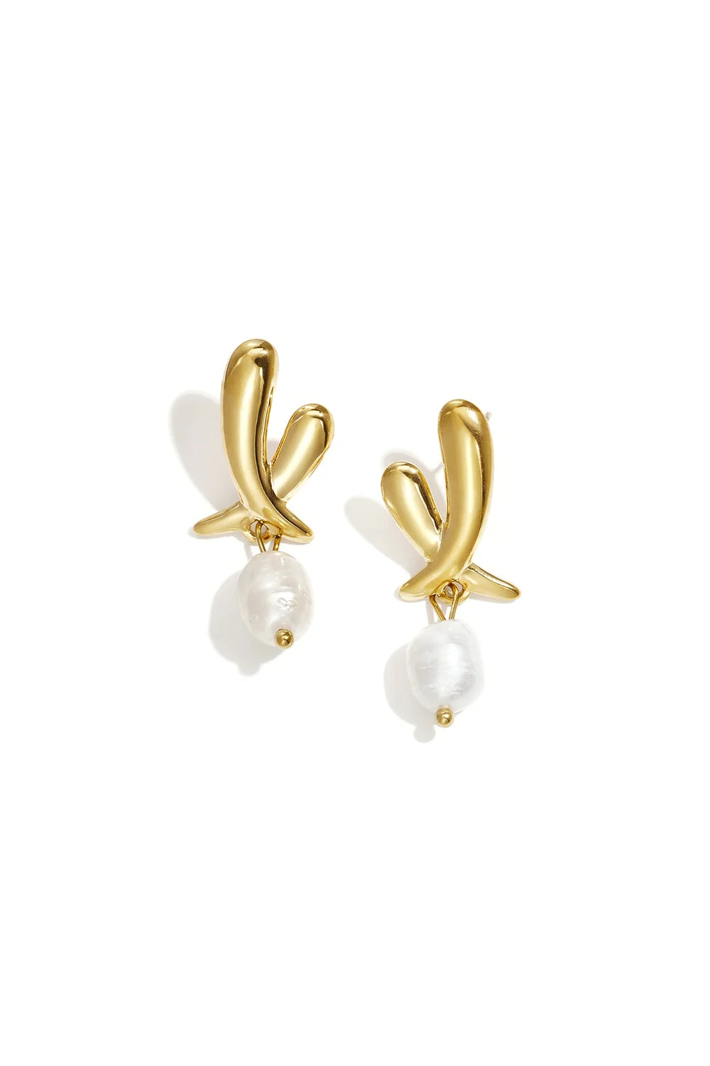 A pair of gold-plated stainless steel stud earrings featuring a smooth abstract fluid gold ribbon knot stud with a dangling irregular white faux baroque pearl against a white background. aria-ribbon-baroque-pearl-drop-earrings.webp