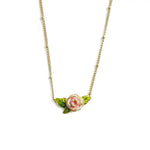 A gold-plated satellite chain necklace by Bill Skinner featuring an integrated 3D rose pendant hand-painted with cream, blush pink, and green leaf enamel.