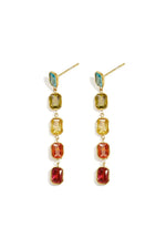 A pair of gold-plated stainless steel linear drop earrings featuring a vertical chain of five multi-coloured emerald-cut cubic zirconia crystals against a white background. camilla-multi-gemstone-linear-drop-earrings.webp