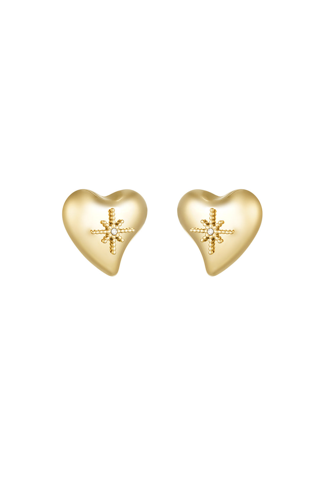 A pair of gold-plated stainless steel stud earrings featuring a smooth, three-dimensional asymmetrical puffy heart with an intricate raised beaded starburst centerpiece holding a clear cubic zirconia crystal against a white background. celeste-puffy-heart-starburst-stud-earrings.webp