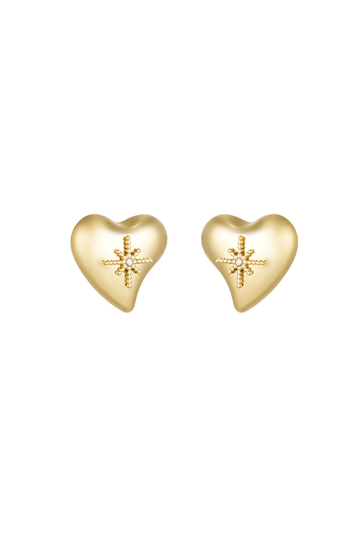 A pair of gold-plated stainless steel stud earrings featuring a smooth, three-dimensional asymmetrical puffy heart with an intricate raised beaded starburst centerpiece holding a clear cubic zirconia crystal against a white background. celeste-puffy-heart-starburst-stud-earrings.webp