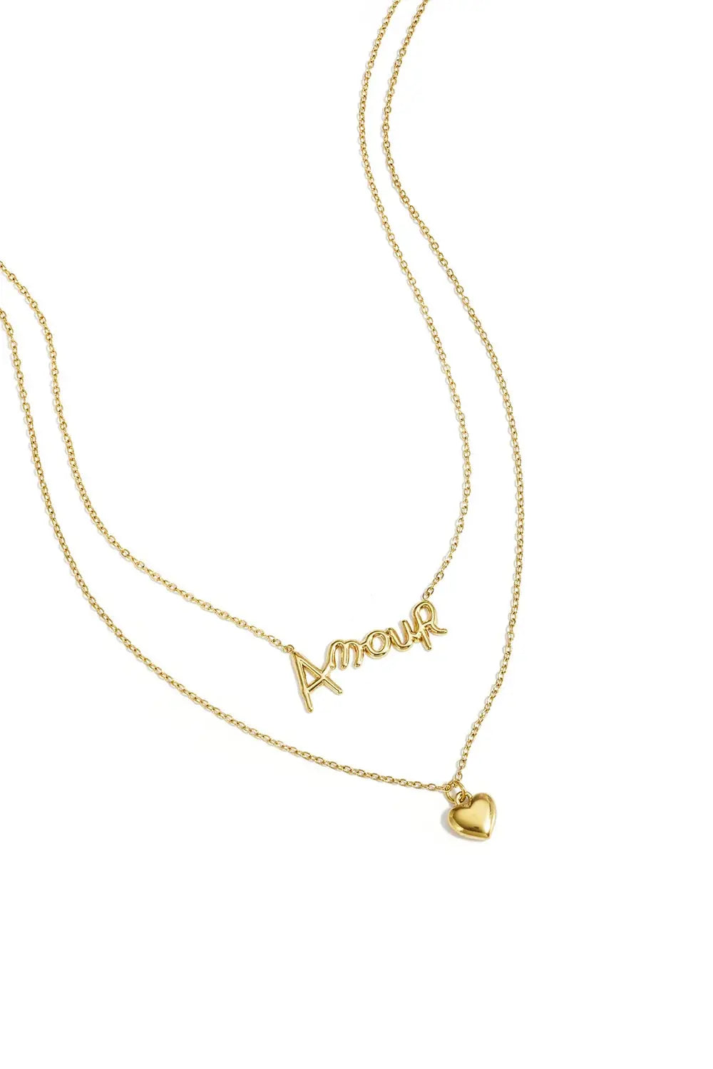 A gold-plated pre-layered double strand necklace featuring a scripted cursive Amour pendant on the top chain and a small 3D puffy heart charm on the bottom chain. cherie-amour-double-layer-heart-necklace.webp