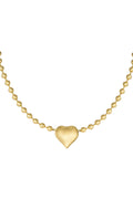 A close-up of a gold-plated stainless steel satellite ball chain necklace featuring a smooth, high-polish three-dimensional puffy heart centerpiece in the middle against a white background. cherie-puffy-heart-satellite-necklace.webp