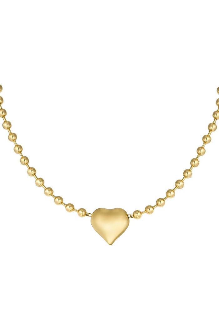A close-up of a gold-plated stainless steel satellite ball chain necklace featuring a smooth, high-polish three-dimensional puffy heart centerpiece in the middle against a white background. cherie-puffy-heart-satellite-necklace.webp