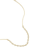 A gold-plated stainless steel necklace featuring a central arc of round cubic zirconia crystal stations connected to a fine link chain against a white background. clara-crystal-station-necklace.webp