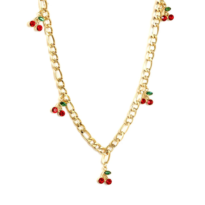 Chunky gold figaro chain with five red crystal cherry charms and green marquise crystal leaf details, on a white background