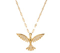 Gold bird pendant necklace with wings and tail encrusted in white crystals, hanging from a gold textured link chain on a white background.