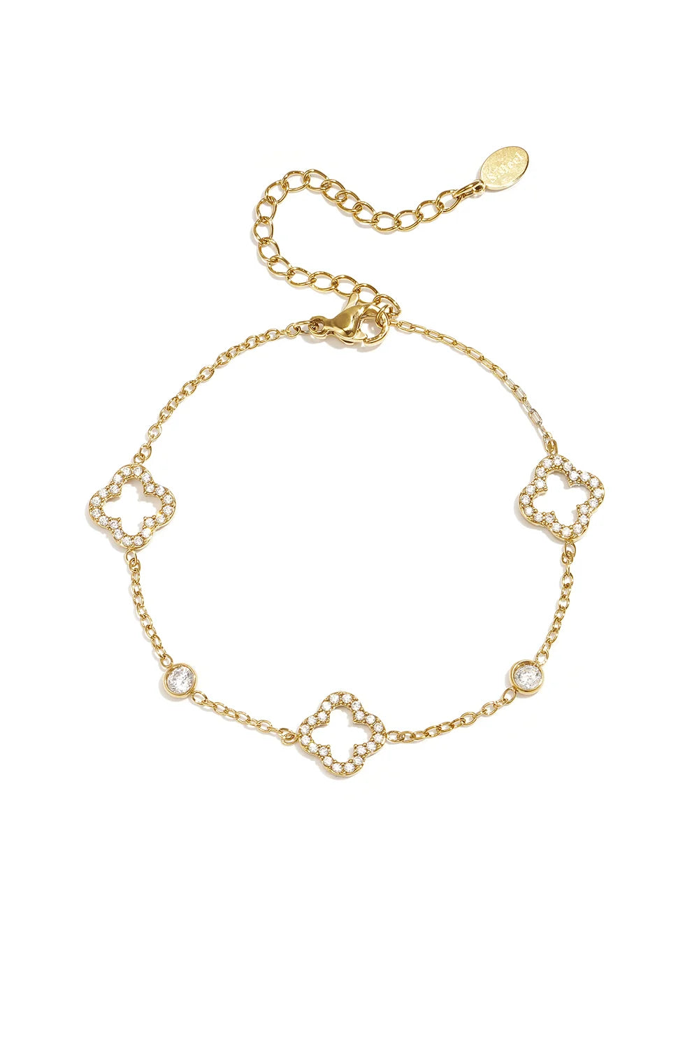 A delicate gold-plated stainless steel chain station bracelet featuring three open quatrefoil clovers lined with clear pavé crystals alternating with two round bezel-set crystal solitaires. giselle-open-clover-bracelet.webp