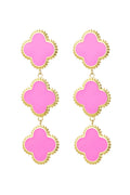 A pair of gold-plated statement drop earrings featuring a vertical cascade of three quatrefoil clovers filled with bright pink enamel and bordered by textured gold beads. giselle-triple-clover-enamel-earrings.webp
