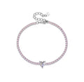A 925 sterling silver tennis bracelet featuring a continuous row of small pastel pink round crystals anchored by a clear white heart-cut crystal centerpiece.