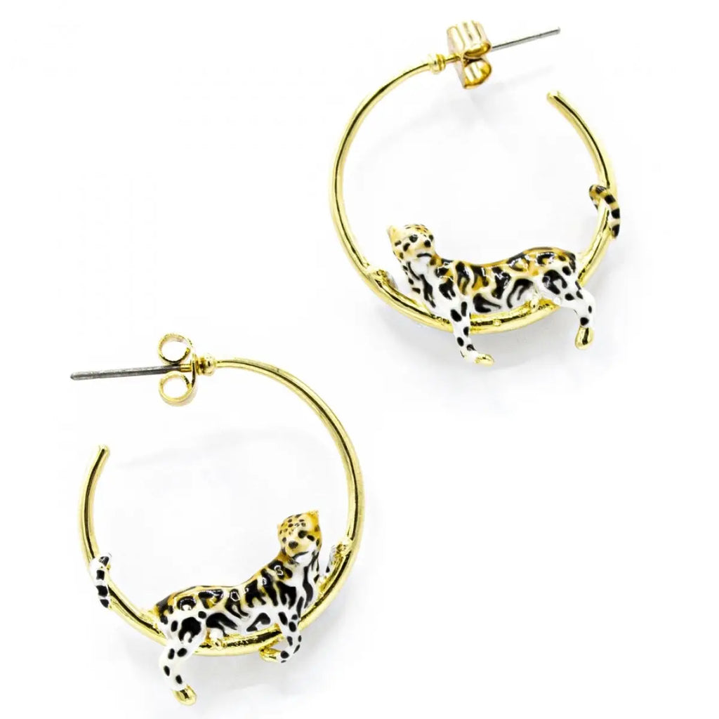 A pair of gold-plated open hoop earrings by Bill Skinner featuring highly detailed 3D lounging leopards hand-painted with white, tan, and black spotted enamel.