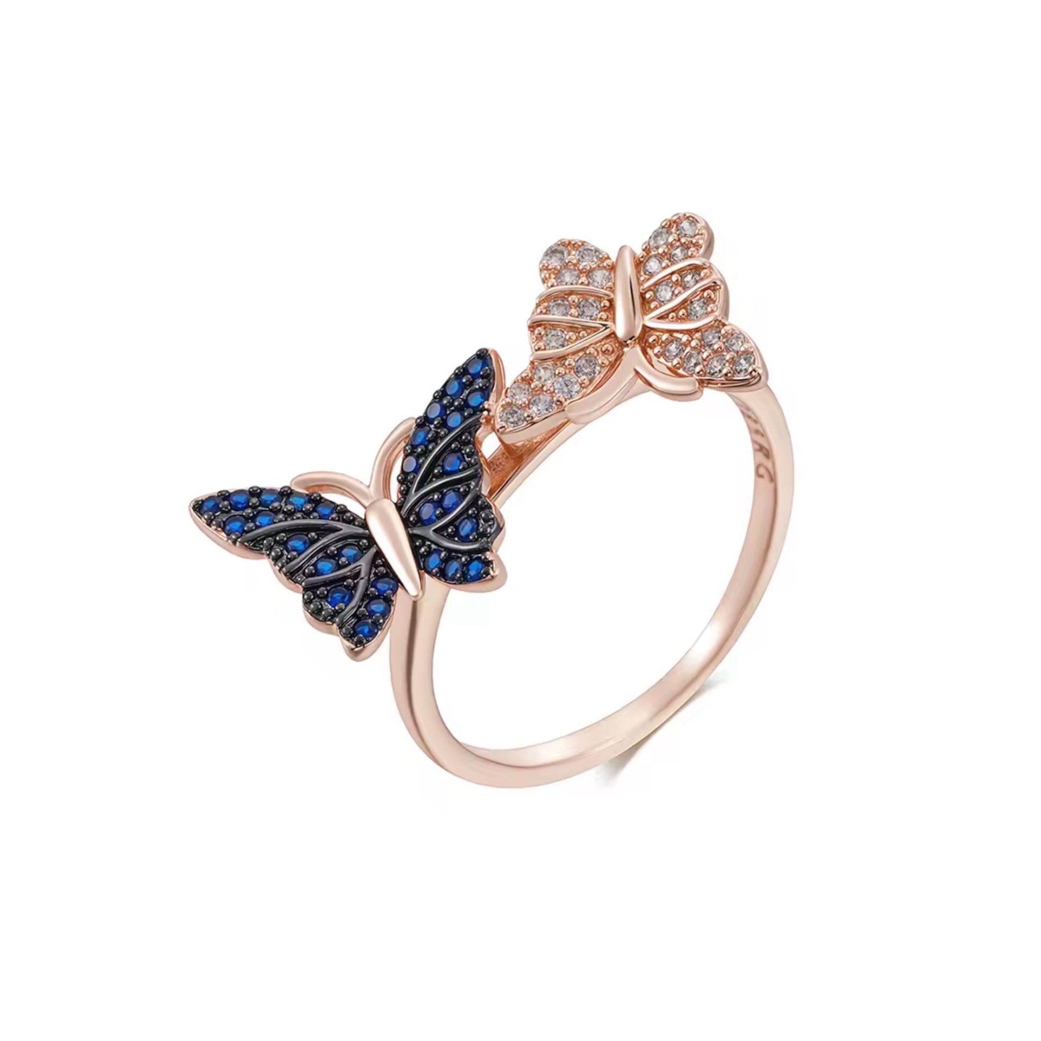 A 585 plated rose gold bypass ring featuring two detailed butterflies, one encrusted with sapphire blue crystals and the other with clear white crystals, on a white background.