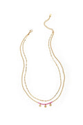 A gold-plated stainless steel multi-layer necklace featuring a top tier textured gold chain and a bottom tier gold satellite chain decorated with hot pink seed beads and three small hanging heart charms. mimi-multi-layer-heart-fringe-necklace.webp