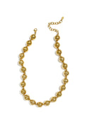 A bold gold-plated strand necklace featuring a continuous row of large, high-polish spherical metallic beads separated by tiny spacer accents. olimpia-necklace.webp