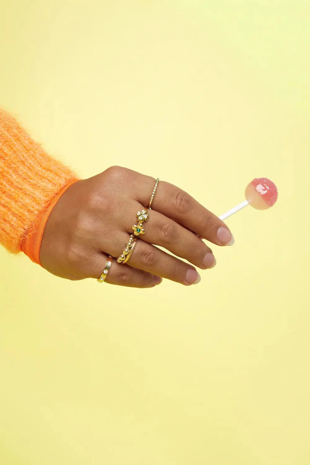 A dainty gold-plated stainless steel waterproof band ring featuring a continuous sculpted ripple wave texture against a plain white background. onda-waterproof-textured-wave-ring.webp