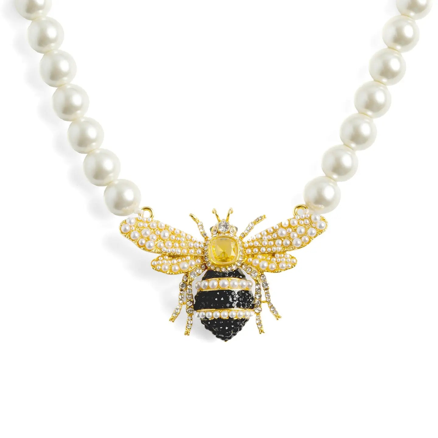 A royal pearl strand necklace by Bill Skinner featuring an oversized central 3D queen bee centerpiece detailed with a yellow crystal, black and clear rhinestones, and seed pearl wings. bill-skinner-queen-bee-pearl-necklace.webp