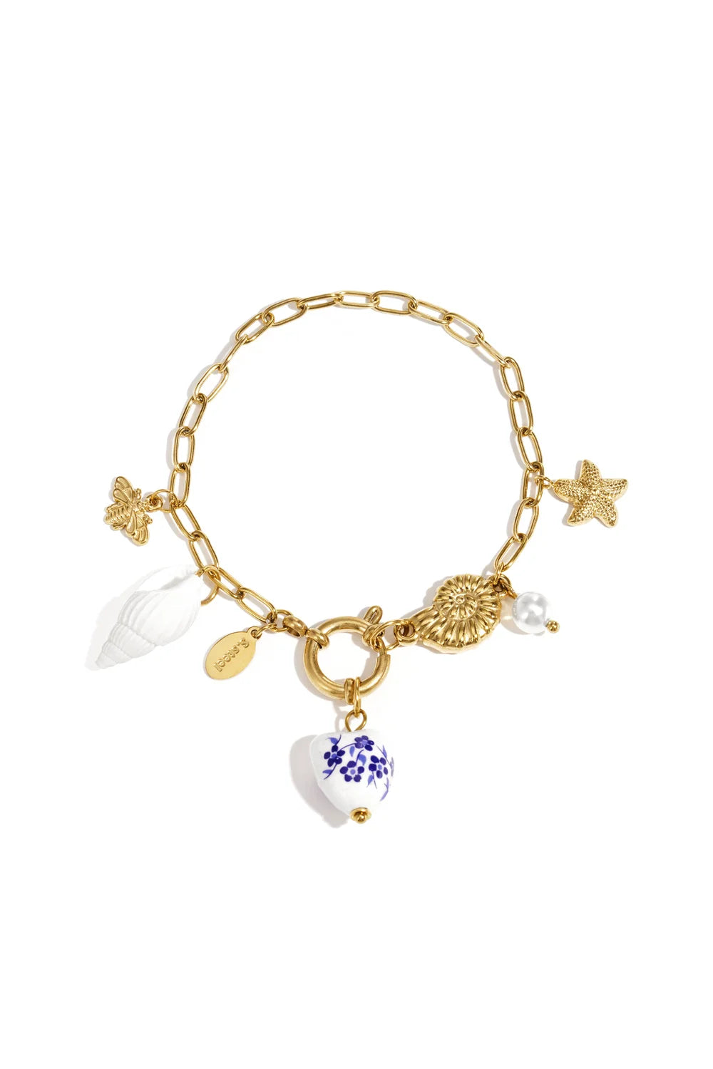 A gold-plated stainless steel charm bracelet featuring a central blue and white hand-painted porcelain floral heart, a white spiral seashell, a golden starfish, a golden ammonite shell, a bee, and a pearl drop. riviera-marine-porcelain-charm-bracelet.webp