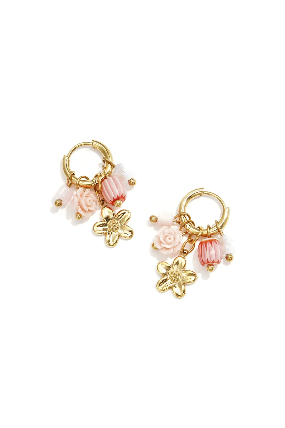 A pair of gold-plated stainless steel huggie hoop earrings featuring a dangling gold flower charm, a carved pink resin rose, a striped pink melon bead, and pastel pink bead accents against a white background. rosalie-rose-flower-charm-huggie-earrings.webp