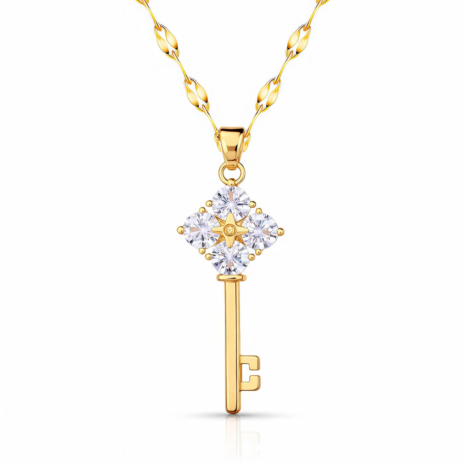 A gold skeleton key pendant necklace with four large clear crystals on the handle, hanging from a gold petal-link chain on a white background.