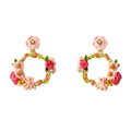 A pair of gold-plated wreath drop earrings by Verdivine featuring intricate hand-painted enamel pink and magenta flowers, green vines, and tiny clear crystal accents. verdivine-flower-wreath-earrings.webp