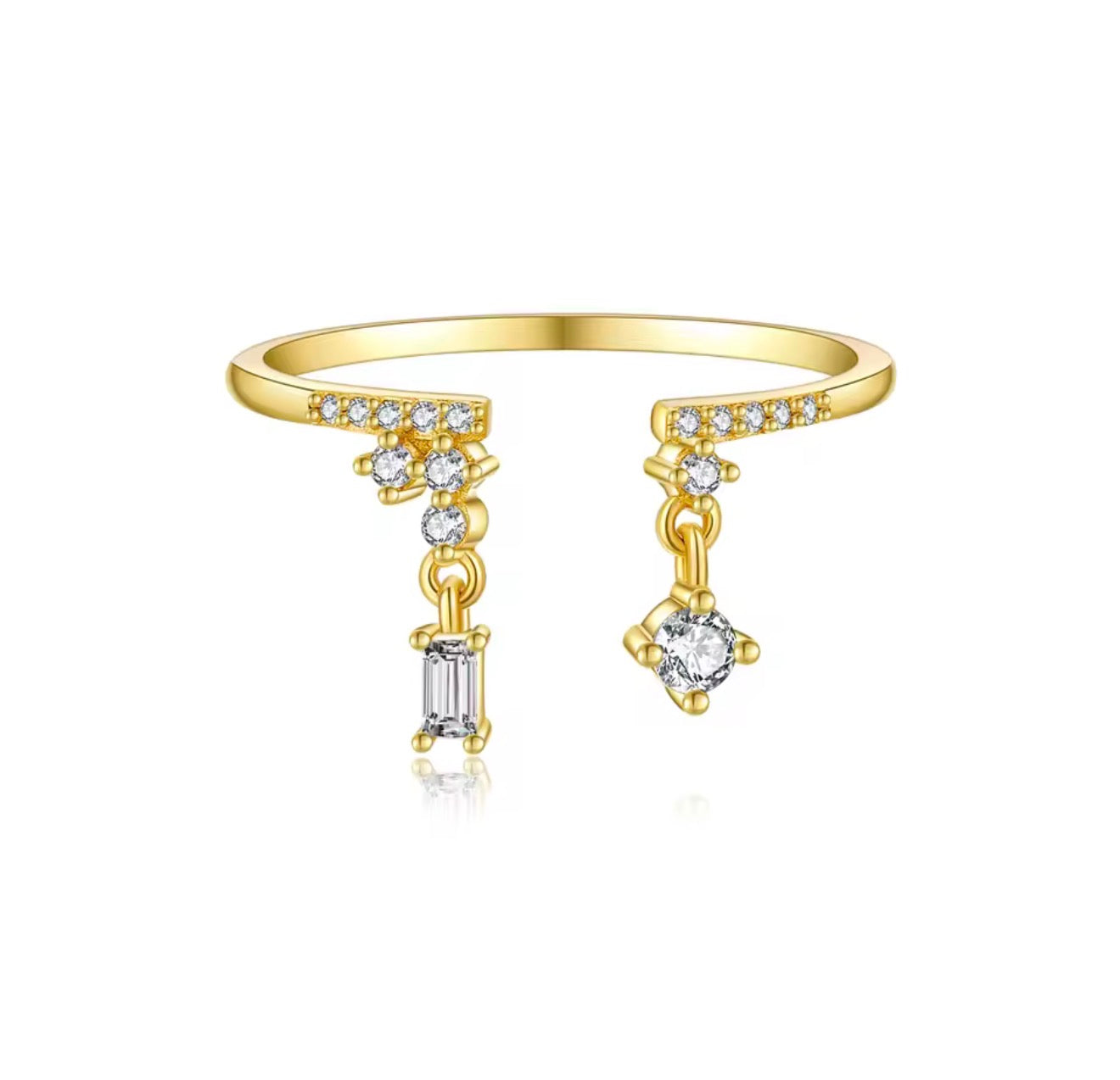 A 925 sterling silver open-front ring featuring pavé crystal shoulders and two asymmetrical dangling charms—one round crystal and one rectangular baguette crystal.
