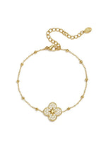 A gold-plated stainless steel satellite chain bracelet featuring a four-leaf clover charm encrusted with pave cubic zirconia and a central golden starburst motif against a white background. seraphina-pave-clover-starburst-satellite-bracelet.webp