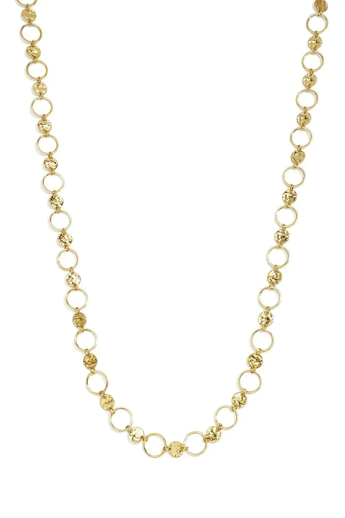 A gold-plated stainless steel statement necklace featuring alternating hammered coin discs and smooth open-circle links against a white background. sienna-hammered-coin-open-ring-statement-necklace.webp