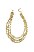 A wide gold-plated stainless steel triple-layer statement necklace composed of three staggered strands of small textured hammered coin discs. sienna-multi-layer-hammered-coin-necklace.webp