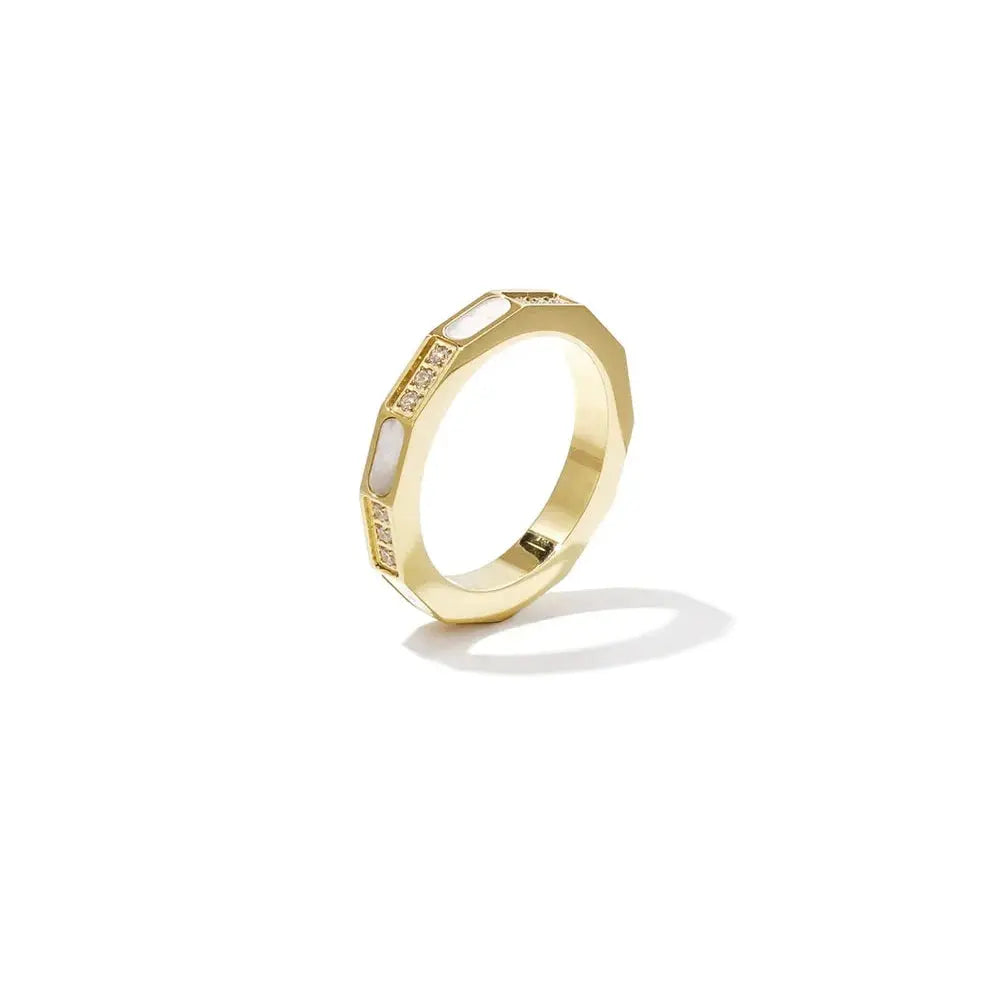 A gold-plated stainless steel ring featuring a faceted geometric band inlaid with alternating segments of white mother-of-pearl and small sparkling cubic zirconia crystals. sienne-mother-of-pearl-ring.webp