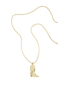 A gold-plated stainless steel ball chain necklace featuring a sculpted cowboy boot pendant with engraved Western stitch detailing against a white background. sierra-western-cowboy-boot-ball-chain-necklace.webp