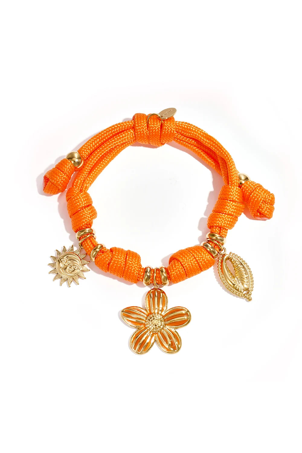 A vibrant orange braided cord bracelet featuring gold charms of a flower, a sun, and a cowrie shell, displayed on a white background.