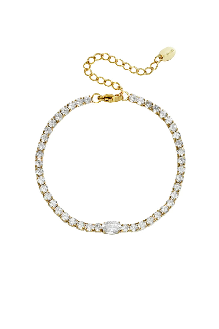 Gold tennis bracelet with round crystals and an oval center stone