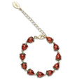 A gold-plated link bracelet by Bill Skinner featuring a continuous row of 3D strawberry charms coated in glossy translucent red and green enamel.