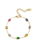A gold-plated stainless steel chain bracelet featuring various cuts of rich jewel-toned cubic zirconia gemstones against a white background. sylvie-multi-cut-gemstone-station-bracelet.webp