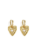 A pair of gold-plated stainless steel huggie hoop earrings featuring fluted heart charm drops with a heart-cut cubic zirconia crystal at the center against a white background. valentina-fluted-heart-crystal-huggie-earrings.webp